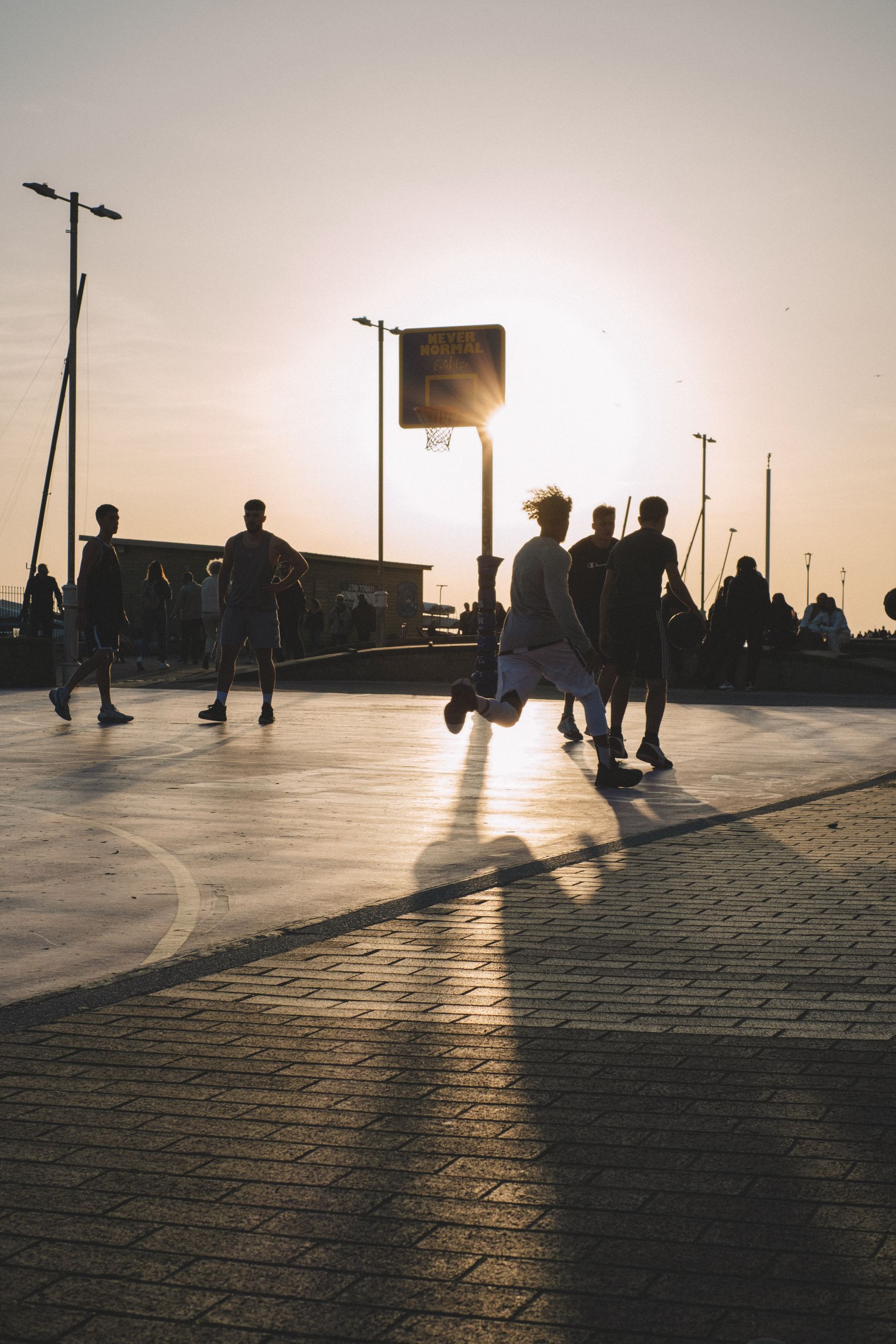 Players sharing a street basketball game in evening light — illustrative stock photograph, not the fictional interview or club