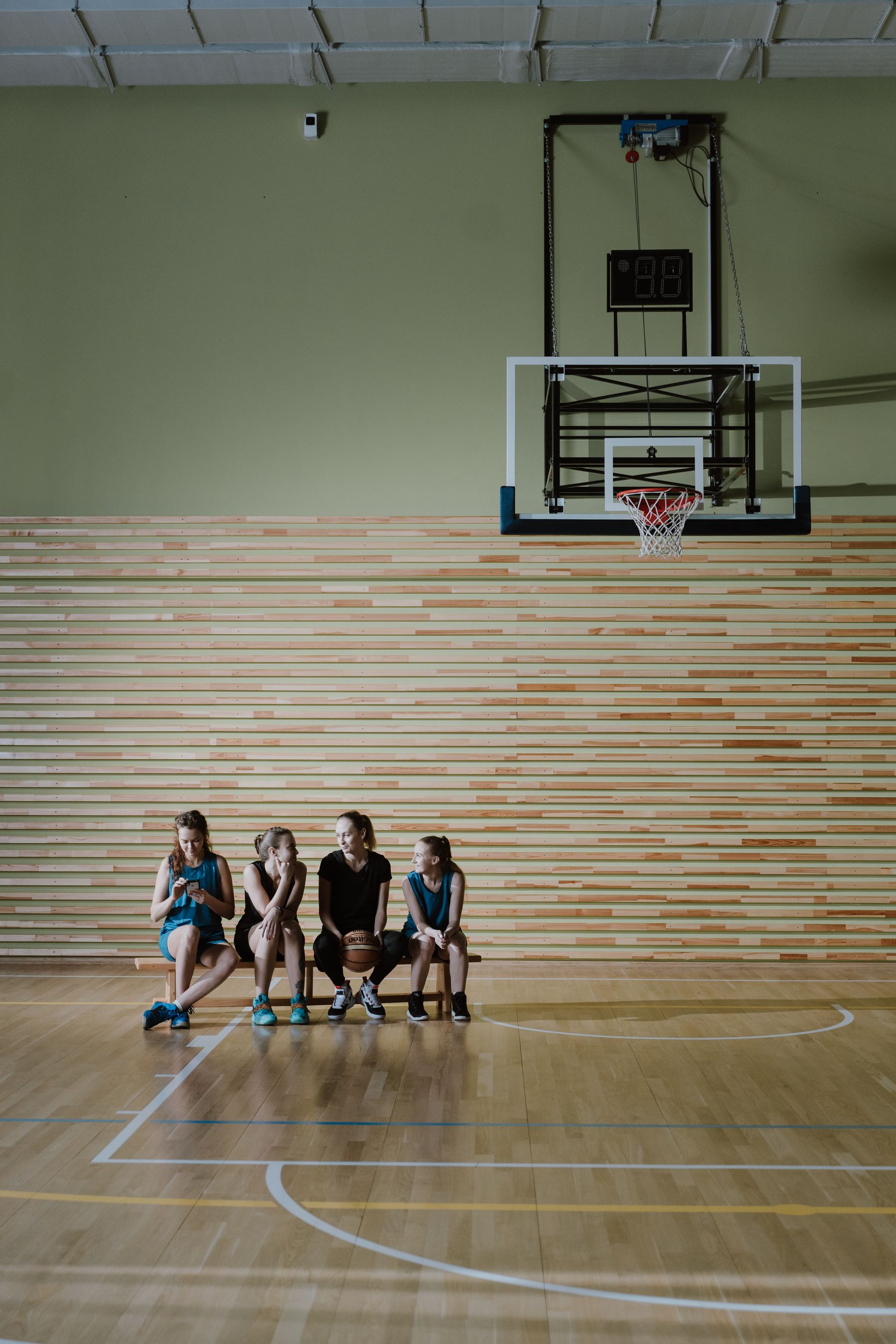 Basketball teammates talking on the bench between play — illustrative stock photograph, not the fictional interview or club