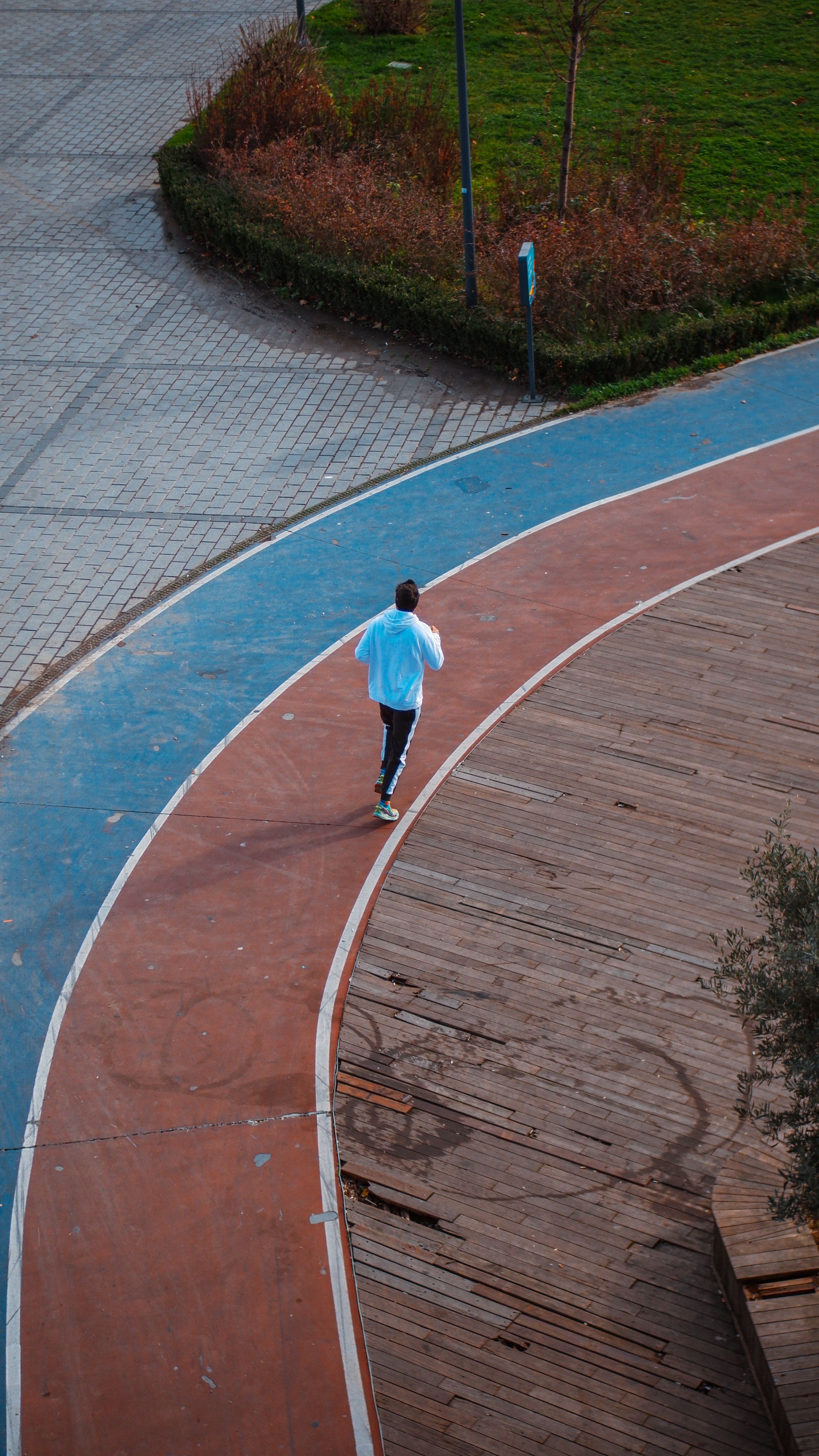 Runner seen from behind on a curved outdoor track