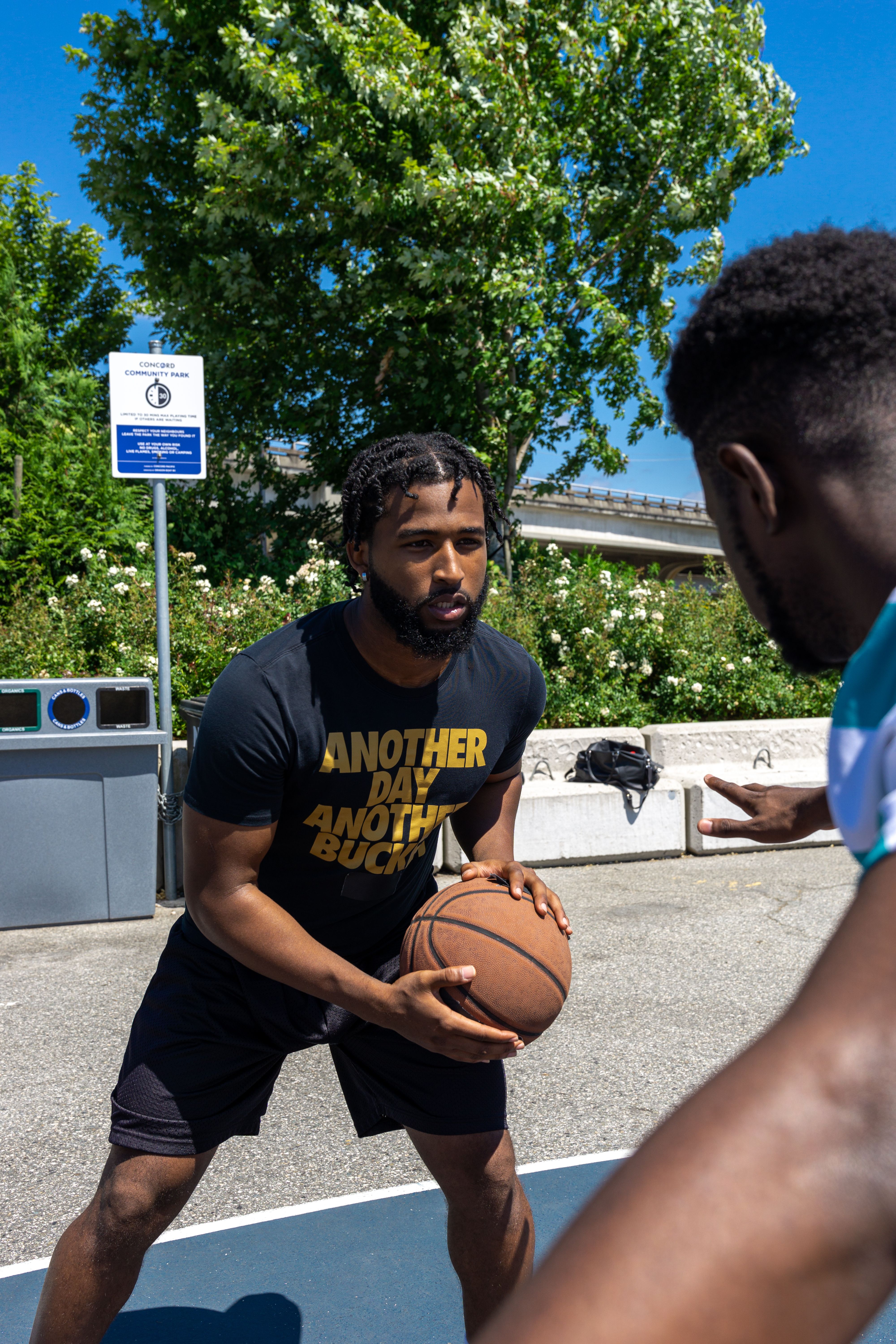 Two friends playing basketball outdoors
